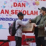 Bupati Hanindito saat memberikan hadiah laptop kepada Nastoto. Foto: Ist. 