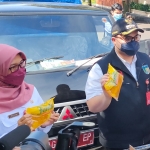 Bupati Kediri Hanindhito Himawan Pramana didampingi Kepala Dinas Perdagangan Tutik Purwaningsih saat mengecek minyak goreng yang akan didistribusikan kepada para pedagang di sejumlah pasar tradisional. foto: MUJI HARJITA/ BANGSAONLINE