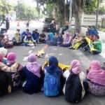 BAKAR POSTER: Mahasiswa PMII Sidoarjo membakar poster saat berunjuk rasa menuntut Perda Penanggulangan AIDS, di depan Gedung DPRD Sidoarjo, Rabu (2/12/2015). Foto: musta’in/ BANGSAONLINE