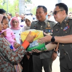 Pj Gubernur Jatim, Adhy Karyono, saat membagikan bantuan di Jember dalam gelaran pasar murah di Kantor Kelurahan Tegal Besar.