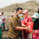 Bupati Gresik Fandi Akhmad Yani memberikan paket sembako kepada pemulung dan petugas kebersihan. foto: SYUHUD/ BANGSAONLINE