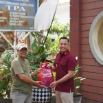 Kepala Kantor Imigrasi Kelas II Non TPI Kediri, Widhi Mosakajaya Arradiko, saat menyerahkan bantuan kepada salah satu warga. Foto: Ist