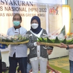 Amel bersama ibunya, Ernie Rofikoh, menyerahkan tumpeng kepada Ketua KWG M. Syuhud Almanfaluty. foto: IST./ BANGSAONLINE