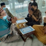 Nona Granita Gharisa dan Andri Marlino Januar Eka Putra usai proses ikrar dua kalimat syahadat yang dituntun oleh Imam Masjid Al-Akbar Surabaya, Imam Nasikh Hidayatullah di Masjid Nasional Al-Akbar Surabaya, Jumat (16/4/2021). foto: MMA/ BANGSAONLINE.com