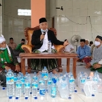 Prof. Dr. KH. Asep Saifuddin Chalim, M.A., saat memimpin istighatsah dan doa bersama di Pondok Pesantren Nurul Qomar di Dusun Pembuwun Desa Suwun Sejati Kecamatan Narmada Kabupaten Lombok Barat, Sabtu (13/3/2021). Tampak banyak botol terbuka berisi air sebagai washilah doa yang dipimpin Kiai Asep Saifuddin Chalim. foto: mma/ bangsaonline.com