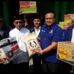 Ketua DPD Nasdem Gresik Syaiful Anwar menyerahkan bantuan simbolis kepada Ketua PCNU Gresik, KH. Chusnan Ali. foto: SYUHUD/ BANGSAONLINE