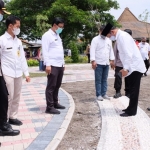 TERAPI SARAF KAKI: Hudiyono mencoba fasilitas batu pijat di Taman Lansia, Rabu (13/1/21). foto: ist.