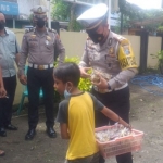 Kasatlantas Polres Blitar AKP I Putu Angga Feriyana saat memborong dagangan peyek yang dijual Tangguh.