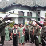 Letkol Inf Akatoto beserta istri mendapat penghormatan pedang pora, tradisi pelepasan kepemimpinan. foto: intan/ BANGSAONLINE