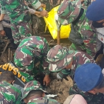 Petugas saat mengevakuasi jenazah korban banjir bandang di Kota Batu.