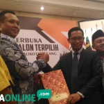 Ketua KPU Kota Malang Zainudin ketika menyerahkan SK penetapan Wali Kota Malang kepada timses paslon Sutiaji dan Sofyan Edi J, Kamis (26/07). foto: IWAN/ BANGSAONLINE
