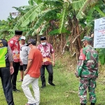 Warga saat memasang spanduk di lahan seluas 3 hektare di Desa Beji, Kecamatan Beji.