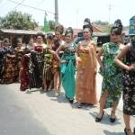 
Para model mengenakan batik saat beraksi di cat walk yang notabene berada di pinggir jalan. Foto: arif kurniawan/BANGSAONLINE
