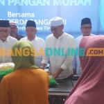 Menteri Perdagangan, Zulkifli Hasan, bersama Kiai Asep, ketika membagikan beras untuk masyarakat di Desa Bendunganjati, Kecamatan Pacet, Kabupaten Mojokerto. Foto: ROCHMAT SAIFUL ARIS/BANGSAONLINE