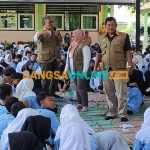 Ketua FPRB Kabupaten Kediri, Ari Purnomo Adi (pegang mik), bersama Siti Fatimah dan Kamid saat menyampaikan materi di hadapan para murid SMPN 1 Tarokan. Foto: MUJI HARJITA/ BANGSAONLINE