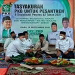 DPC PKB Gresik saat menggelar tasyakuran atas terbitnya Perpres Nomor 82 Tahun 2021. foto: SYUHUD/ BANGSAONLINE