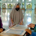 Feroline Bella Falencia dan Poppy Triyani Ningtyas JK saat proses ikrar kalimat syahadat dibimbing KH Ahmad Nasikh Hidayat di masjid Al Akbar Surabaya, Jumat (17/9/2021). foto: mma/ bangsaonline.com