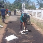 Tim Satgas jalan berlubang Dinas PUCKPP Banyuwangi saat memperbaiki jalan. Foto : ist