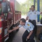 Petugas di jembatan timbang yang melakukan pengecekan tanda uji angkutan barang.