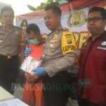 Tersangka bersama barang bukti uang hasil pemerasan saat digelar di Mapolres Kediri. foto: ARIF K/ BANGSAONLINE