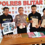 Kapolres Blitar AKBP  Slamet Waloya menunjukkan barang bukti uang tunai yang diduga hasil pungli. foto: AKINA/ BANGSAONLINE