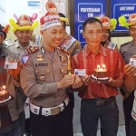 Kasatlantas Polres Kediri Kota AKP A. Rizki Fardian saat memberikan kue ulang tahun dan penerbitan SIM gratis kepada 5 pemohon yang lahir tanggal 1 Juli. foto: ARIF KURNIAWAN/ BANGSAONLINE