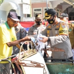 Kapolres Pamekasan,  AKBP Apip Ginanjar, S.I.K., M.Si., bersama forkopimda saat membagikan masker kepada para pengendara bermotor dan para abang becak. (foto: ist).