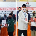 Pasangan Niat (kiri) dan QA ketika mendaftar di KPU Gresik. foto: SYUHUD/ BANGSAONLINE