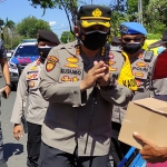 Kapolresta Sidoarjo Kombes Pol. Kusumo Wahyu Bintoro membagikan sebanyak 300 paket sembako kepada pedagang kaki lima dan tukang becak, Minggu (11/7/2021). (foto: ist)