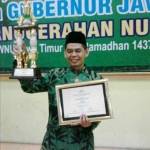 Sekretaris PCNU Magetan Ahmad Sudarto SPdI mengangkat piala dan piagam NU Award Jatim. foto istimewa