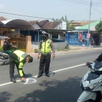 Petugas melakukan olah TKP di titik korban tertabrak truk.